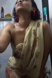 Horny Lily in shower exposing her juicy breast in a wet see thru sari