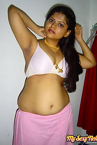 Delicious Neha stripping her pink saree off showing pussy
