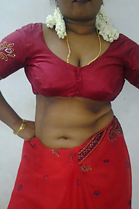Mature Indian housewife taking her Indian outfits off in bedroom