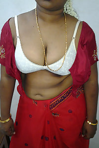 Mature Indian housewife taking her Indian outfits off in bedroom