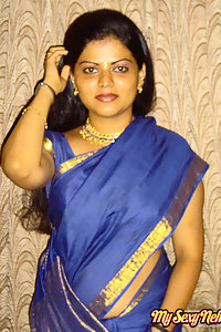 Hot and sexy Neha Nair in blue south Indian sari